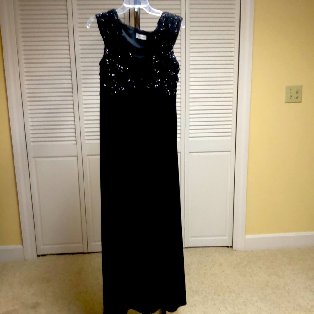 Gorgeous black dress with sequins on the top.